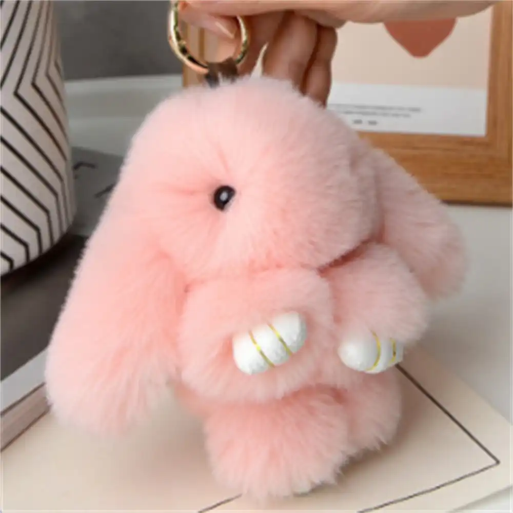Rabbit fur bag charm on car keychain showing versatile decoration for automotive accessories.