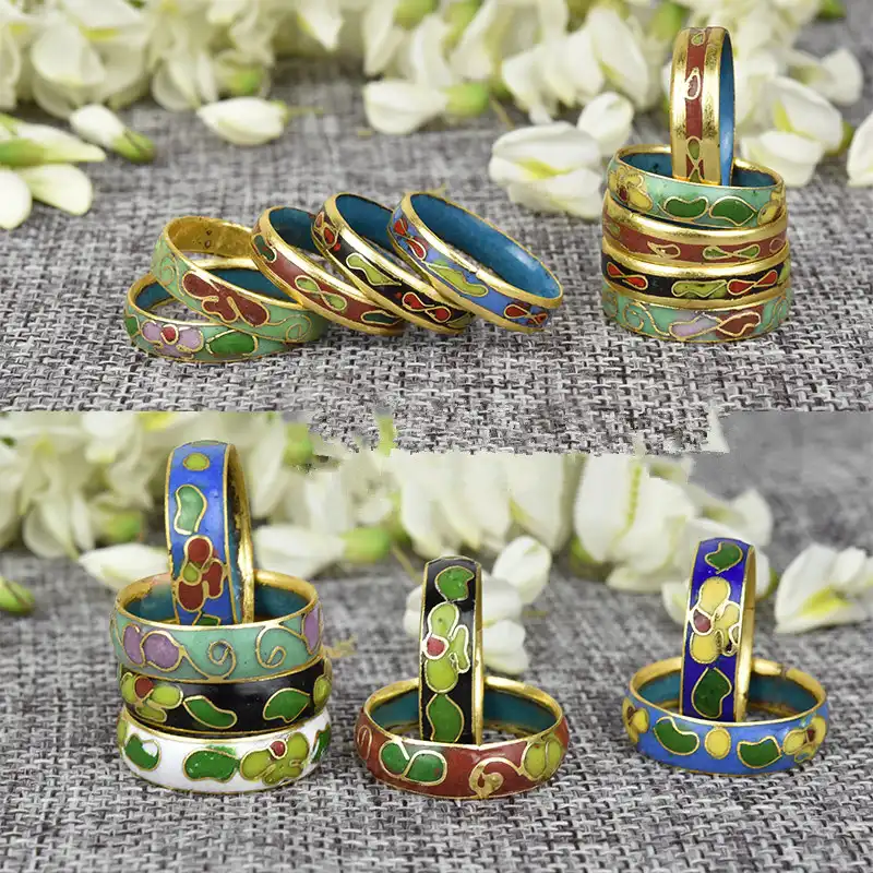 Collection of cloisonne rings arranged by color showcasing traditional Beijing art.