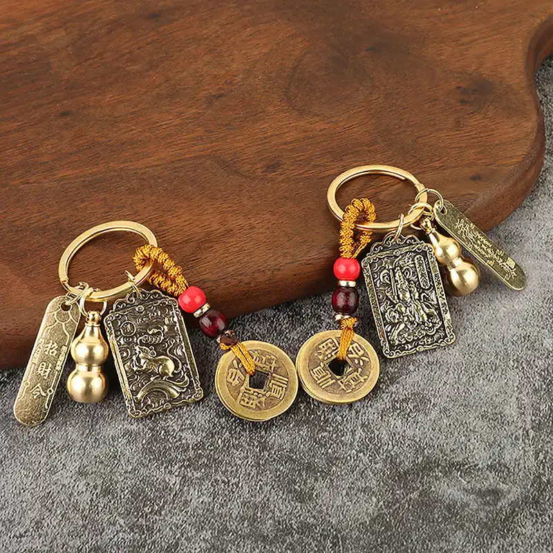 Multiple angle view of Chinese style gourd keychain with five emperor coins for feng shui luck.