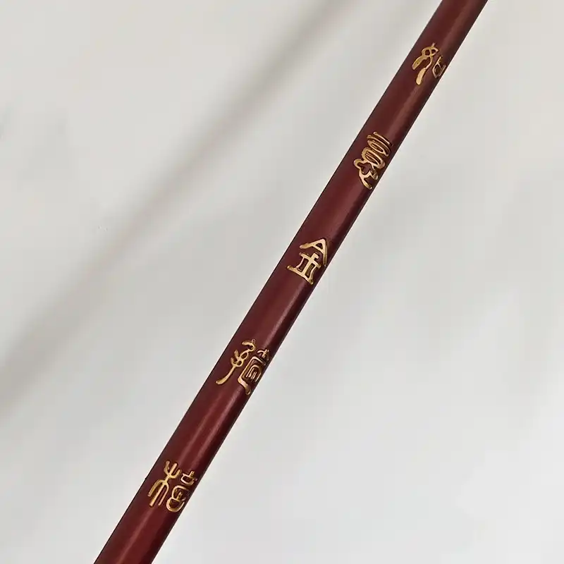 Detailed view of Chinese cultural design elements incorporated into modern weapon replica styling.