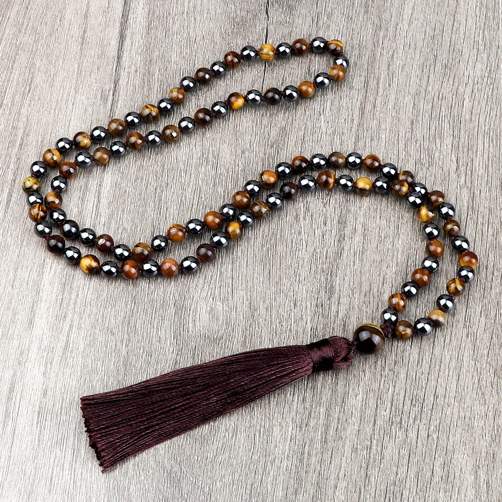 Traditional Buddhist mala necklace displayed with meditation cushion and candles.