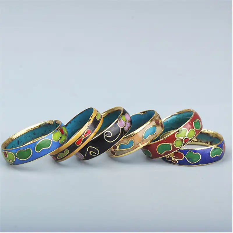 Detailed macro shot of cloisonne ring surface texture and vibrant enamel colors.